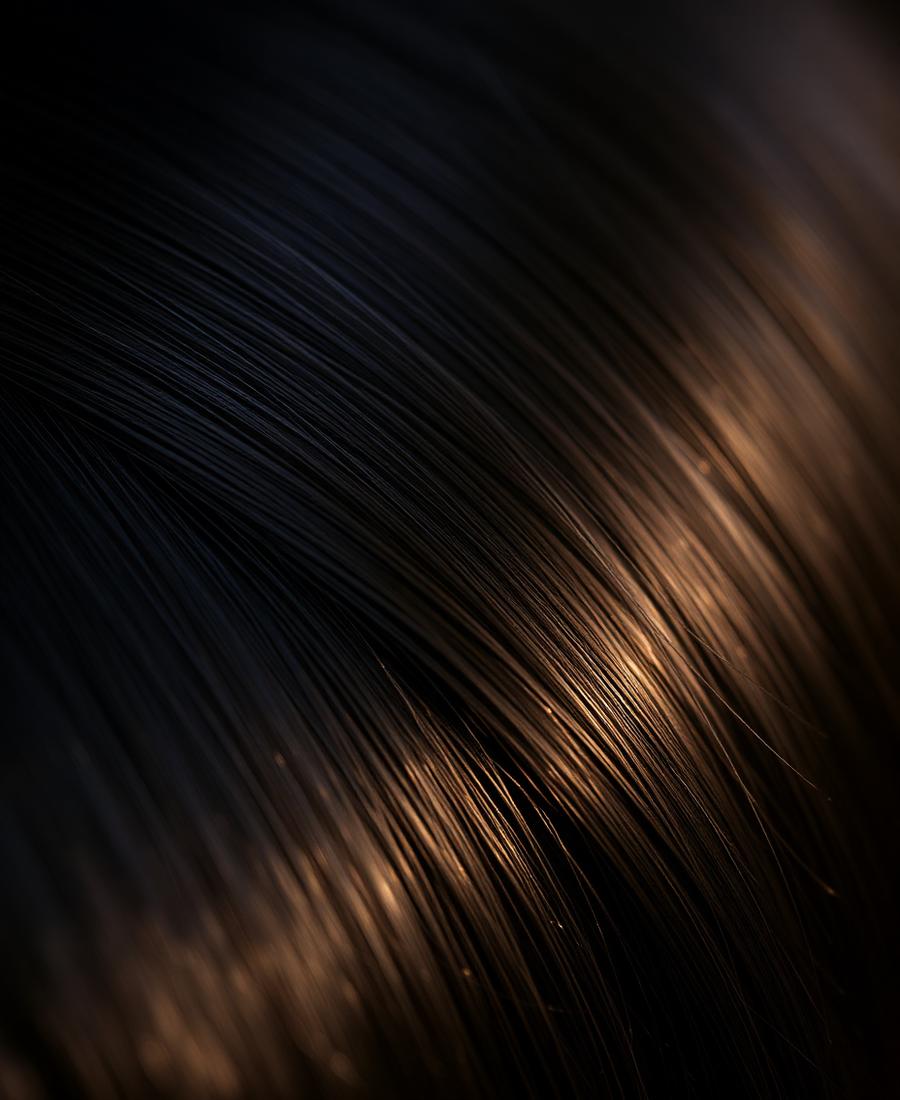 Close-up of healthy hair texture with golden light reflections